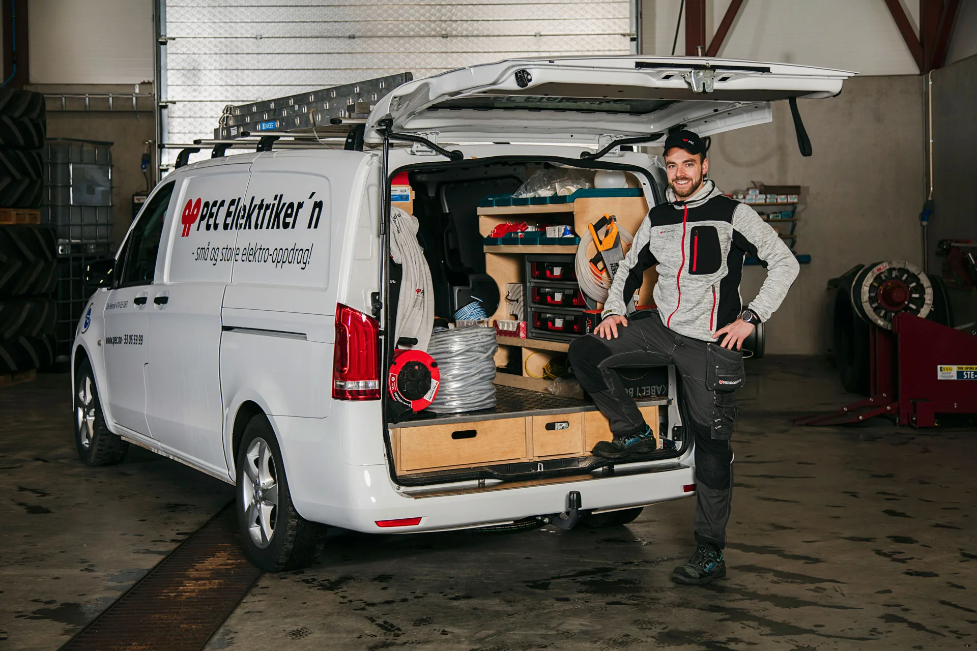 An electrician beside a fitted service van at PEC.