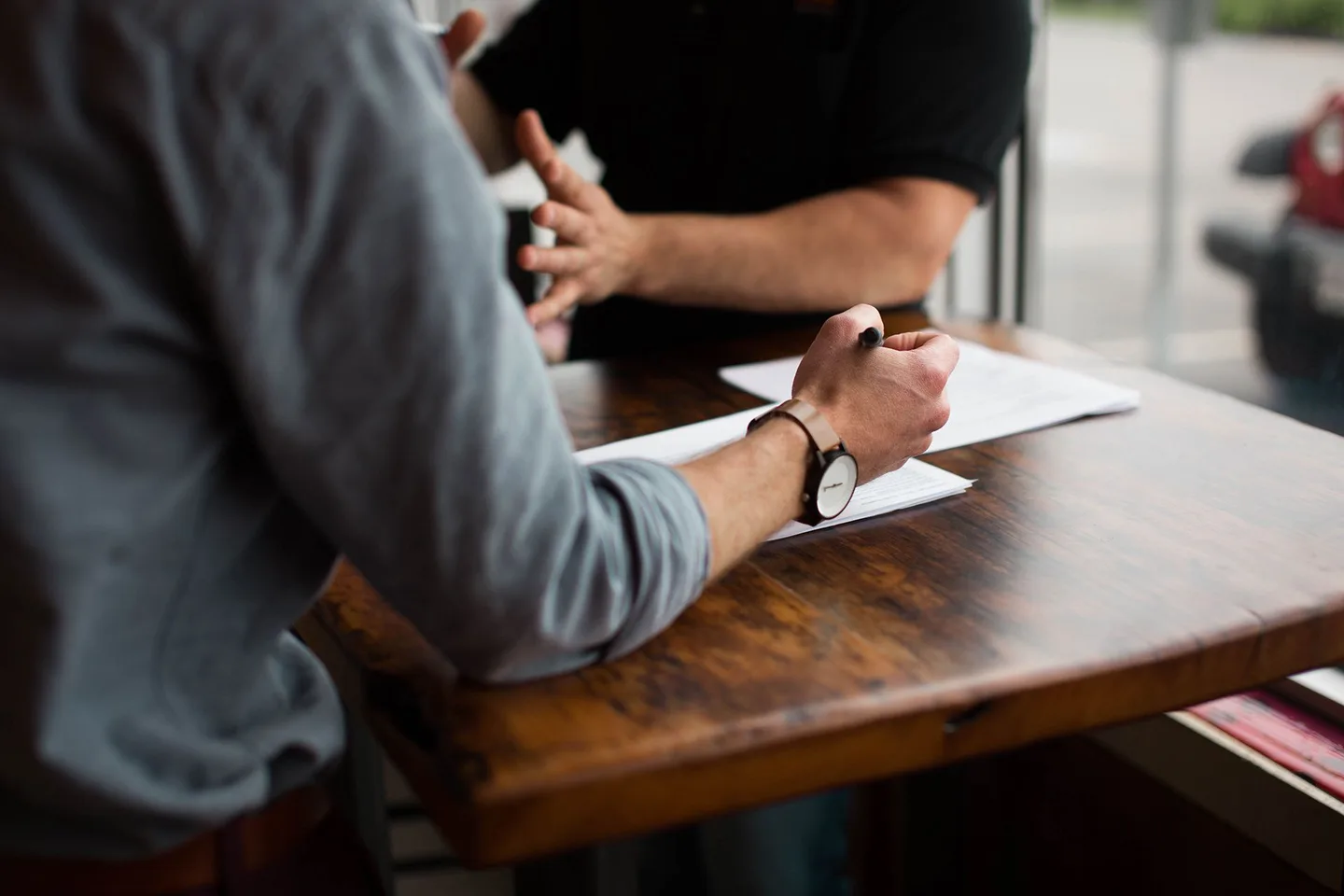 People in conversation with notes on the table.