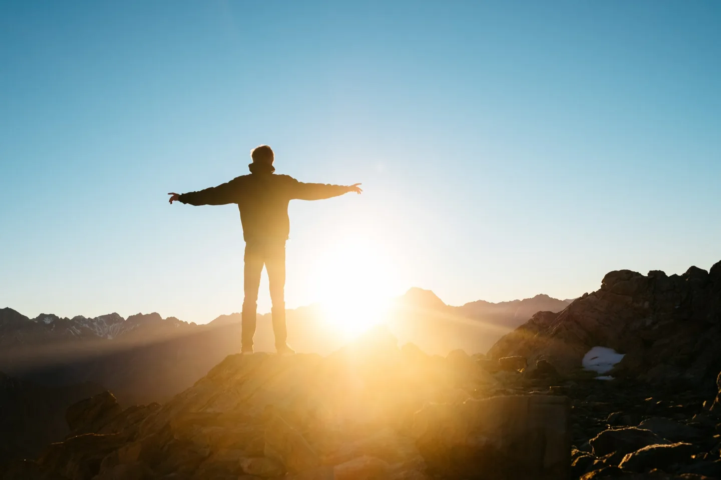 A person in a landscape at sunset.